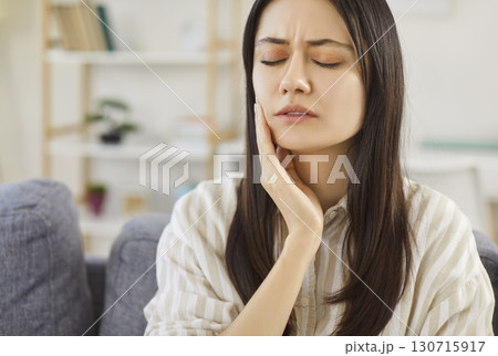 Upset Woman With Toothache At Home Upset Woman With Toothache At Home 130715917