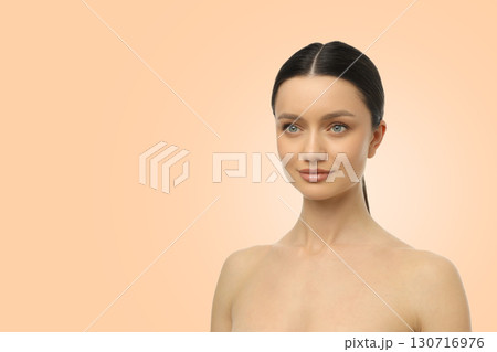 Model displaying flawless skin and subtle makeup in a studio 130716976