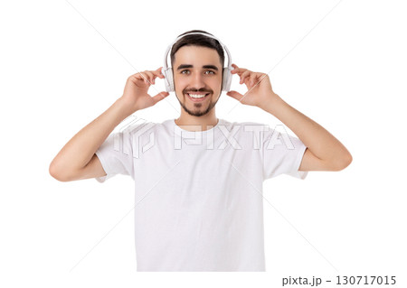 Man joyfully interacts with headphones, isolated, PNG 130717015