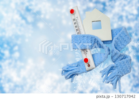 Thermometer wrapped with a cozy scarf representing heating needs 130717042