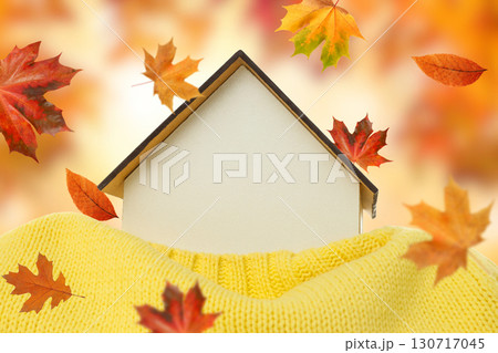 Warm and inviting home nestled in a soft sweater with leaves Warm and inviting home nestled in a soft sweater with leaves 130717045
