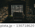Weathered Bible in Rustic Stone Room Illuminated by Dim Window Light 130718620