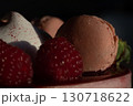 Close-Up of Raspberry and Macaron Dessert in Dramatic Lighting 130718622