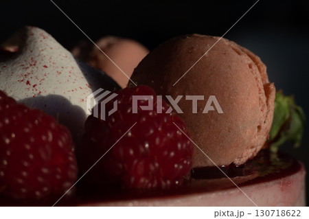 Close-Up of Raspberry and Macaron Dessert in Dramatic Lighting 130718622