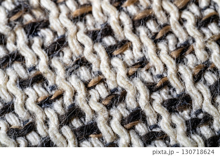 Close-Up of Intricate Black and White Woolen Knit Fabric Texture 130718624