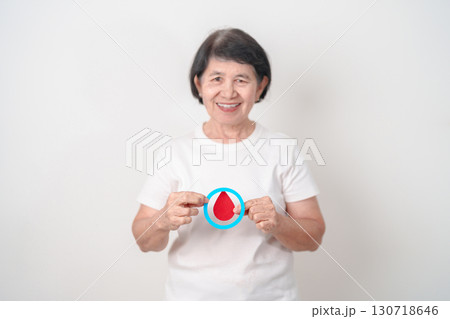 Elderly woman with Blue Circle and red Blood drop for World Diabetes Day, Blue November Health month, Diabetes awareness, Blood sugar check, Insulin, Glucose screening, donation and Health checkup Elderly woman with Blue Circle and red Blood drop for World Diabetes Day, Blue November Health month, Diabetes awareness, Blood sugar check, Insulin, Glucose screening, donation and Health checkup 130718646
