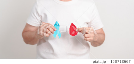 Elderly woman with Blue ribbon and red Blood drop for World Diabetes Day, Blue November Health, Prostate Cancer awareness, Blood sugar check, Insulin, Glucose screening, donation and Health checkup Elderly woman with Blue ribbon and red Blood drop for World Diabetes Day, Blue November Health, Prostate Cancer awareness, Blood sugar check, Insulin, Glucose screening, donation and Health checkup 130718667