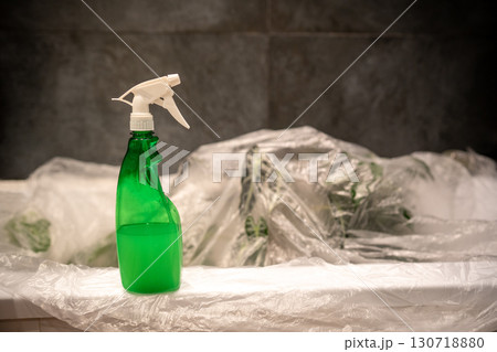 Treating houseplants with insecticide to kill spider mites. Spray bottle with acaricide closeup. Treating houseplants with insecticide to kill spider mites. Spray bottle with acaricide closeup. 130718880