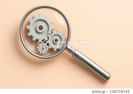 Silver magnifying glass focusing on rotating mechanical gear wheels on clean pastel background, symbolizing innovation and problem solving with bright and clear design 130719142