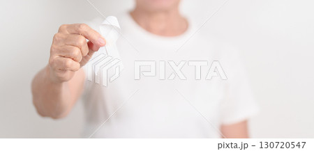 Elderly with White ribbon for concept November Lung Cancer Awareness month, Stop Violence Against Women, Adoption, May Retinoblastoma, Action for Women Health, March Remembrance, October Osteoporosis 130720547