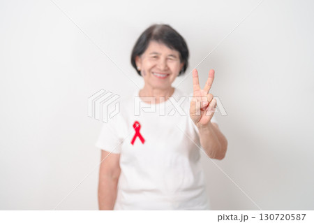 Elderly with Red Ribbon for December World Aids Day, MADD, October Red ribbon week, February Heart month, Marfan Syndrome, May Stroke awareness, March world TB Tuberculosis day and April Dare day 130720587