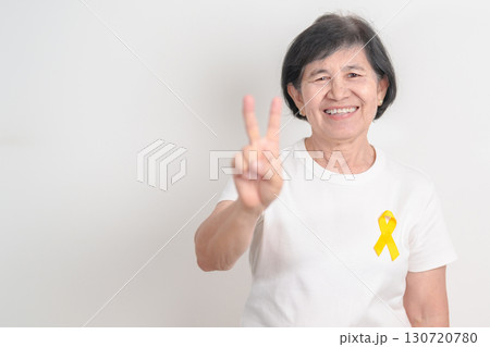 Elderly with Yellow Ribbon for concept of yellow September, Suicide prevention day, Childhood, July Sarcoma, support Our Troops and Military support. Healthcare and World Cancer day 130720780