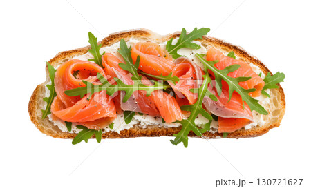 Open sandwich with smoked salmon, cream cheese, and arugula on toasted bread. Fresh gourmet appetizer. Isolated on transparent background. Open sandwich with smoked salmon, cream cheese, and arugula on toasted bread. Fresh gourmet appetizer. Isolated on transparent background. 130721627