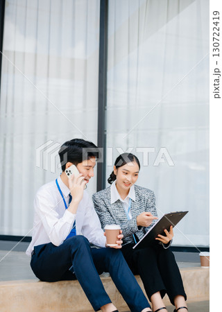 Businesswoman and man going in city center in smart casual business style, talking, working together, stylish 130722419