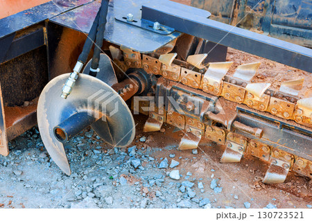 Close up of ground excavation tool on heavy machinery, highlighting its metal blades 130723521