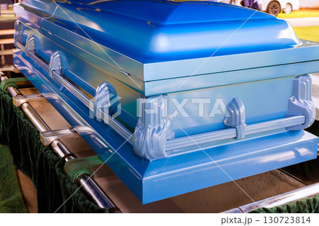 Blue casket is prominently placed at memorial cemetery during solemn funeral ceremony Blue casket is prominently placed at memorial cemetery during solemn funeral ceremony 130723814