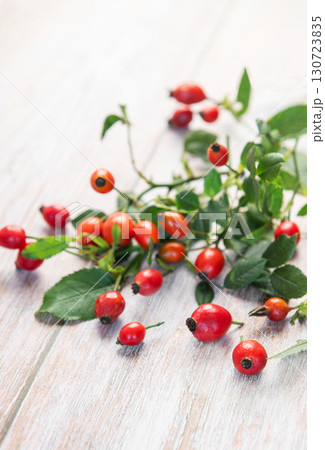 Fresh rose hips lying on rustic white table Fresh rose hips lying on rustic white table 130723835