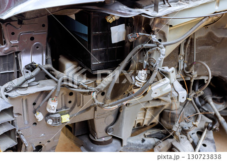 Complex wiring electrical components are visible in vehicle undergoing maintenance during repairs suspension Complex wiring electrical components are visible in vehicle undergoing maintenance during repairs suspension 130723838