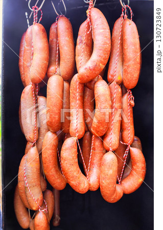 Sausages are freshly prepared hanging in smokehouse to dry and enhance flavor in rural environment. Sausages are freshly prepared hanging in smokehouse to dry and enhance flavor in rural environment. 130723849