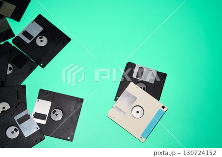 Overhead view of old black and white floppy disks placed on blue background in studio 130724152