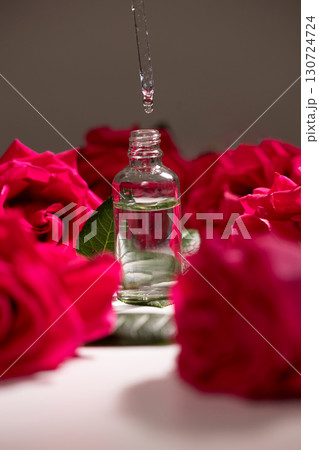 Creating a Fragrant Rose Oil Using a Dropper and Fresh Rose Petals in a Peaceful Setting 130724724