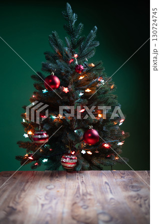 Merry Christmas Postcard Featuring a Decorated Tree With Festive Lights on a Wooden Surface Merry Christmas Postcard Featuring a Decorated Tree With Festive Lights on a Wooden Surface 130724745