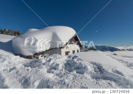 Small house covered in snow Small house covered in snow 130724856