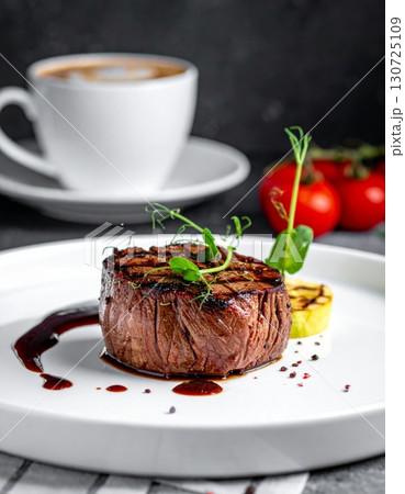 Grilled beef steak with roasted vegetables on a plate for a delicious dinner Grilled beef steak with roasted vegetables on a plate for a delicious dinner 130725109