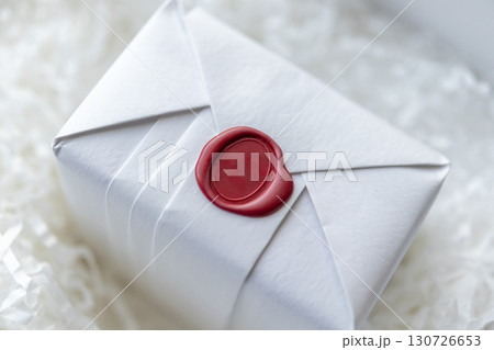 Wax seal stamp on white paper wrap packaging parcel box 130726653