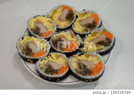 Savory kimbap filled with fresh ingredients paired with hearty, nourishing miyeok guk seaweed soup, creating a perfect combination of light, flavorful, and comforting Korean dishes in every bite. Savory kimbap filled with fresh ingredients paired with hearty, nourishing miyeok guk seaweed soup, creating a perfect combination of light, flavorful, and comforting Korean dishes in every bite. 130726794