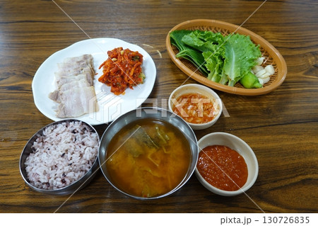 A vibrant spread of Korean food on the table, featuring various banchan (side dishes) like kimchi, pickled vegetables, and seasoned greens. Perfect for food photography, showcasing traditional Korean. A vibrant spread of Korean food on the table, featuring various banchan (side dishes) like kimchi, pickled vegetables, and seasoned greens. Perfect for food photography, showcasing traditional Korean. 130726835