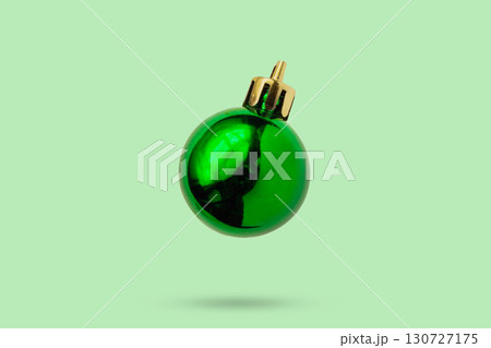 Green Christmas ball isolated on green background 130727175