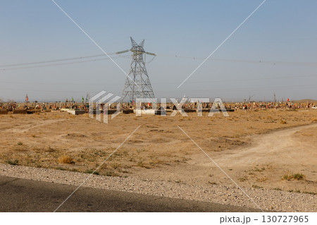 Traditional cemetery with colorful flags on graves in a desert landscape in Kunduz Afghanistan Traditional cemetery with colorful flags on graves in a desert landscape in Kunduz Afghanistan 130727965