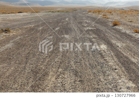 Empty dirt road through the arid desert landscape of Kunduz Province in northern Afghanistan Empty dirt road through the arid desert landscape of Kunduz Province in northern Afghanistan 130727966