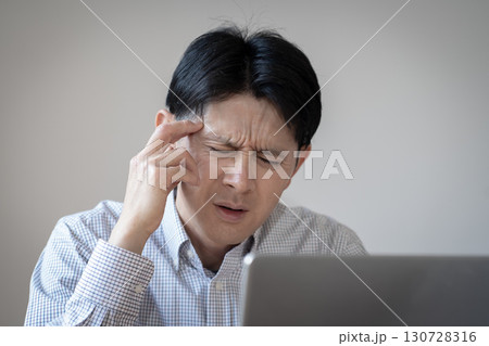 体調不良の男性　頭痛　 130728316