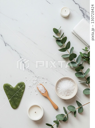 Clean Beauty Product Flatlay with Jade Gua Sha, Sea Salt, and Eucalyptus Branches on White Marble Surface Clean Beauty Product Flatlay with Jade Gua Sha, Sea Salt, and Eucalyptus Branches on White Marble Surface 130728424