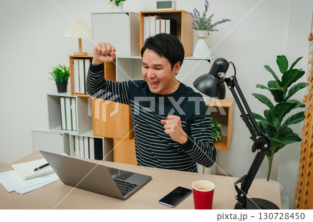success woman working with laptop computer at home office success woman working with laptop computer at home office 130728450