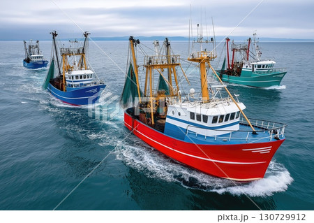 Fishing vessels sailing in formation on open sea 130729912