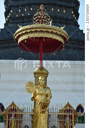 Golden Buddha statue in front of the 12 Zodiac pagoda at Wat Den Sali Si Mueang Kaen. 130730004