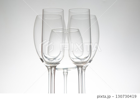Five stylish wine glasses with unique contours, their reflections mirrored 130730419