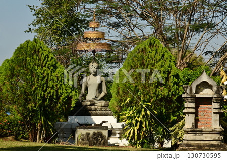 The outdoor sitting stone Buddha statue decoration at Wat Den Sali Si Mueang Kaen temple or Wat Ban Den. Located at Chiang Mai Province in Thailand. The outdoor sitting stone Buddha statue decoration at Wat Den Sali Si Mueang Kaen temple or Wat Ban Den. Located at Chiang Mai Province in Thailand. 130730595