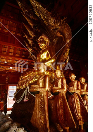 Golden sitting Buddha statue and there is a serpent covering the back in Buddhist Thai Church at Wat Den Sali Si Mueang Kaen temple. Located at Chiang Mai city in Thailand. Golden sitting Buddha statue and there is a serpent covering the back in Buddhist Thai Church at Wat Den Sali Si Mueang Kaen temple. Located at Chiang Mai city in Thailand. 130730632
