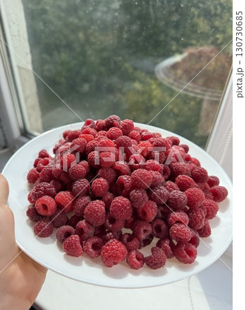 Pile of fresh red raspberries rotating. Sweet harvest. Organic vitamin product. Juicy raspberries. Stack of berries. Vertical video. Fruit pattern. Concept of healthy food. Close-up in 4K, UHD 130730685