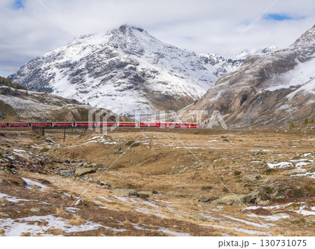 Bernina, Switzerland - October 5th 2024: Red train of Bernina Express in high alpine surrounding 130731075