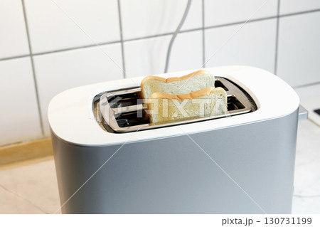 Toaster with two pieces of roasted bread 130731199