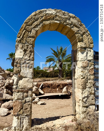 Stone archway of ancient ruins against blue sky. Stone archway of ancient ruins against blue sky. 130731418