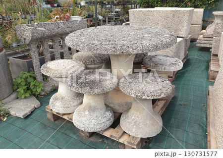 Outdoor furniture made of natural stone for garden in European stores. Gardening and hobby. Nature and plants. 130731577