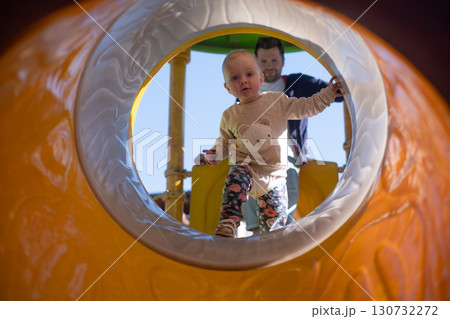 Child playing on outdoor playground. Healthy summer activity for children. Child playing on outdoor playground. Healthy summer activity for children. 130732272
