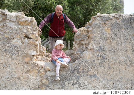 girl and grandfather posing at fortress ruins in Portugal girl and grandfather posing at fortress ruins in Portugal 130732307