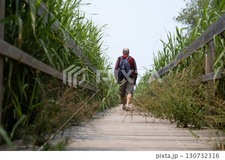 elderly man walking on tourist trail in nature reserve, Portugal elderly man walking on tourist trail in nature reserve, Portugal 130732316